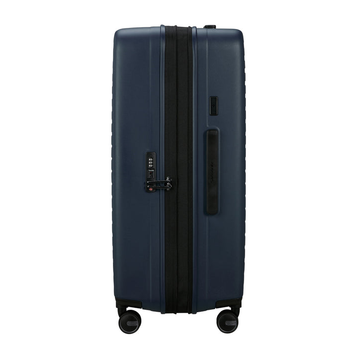 75cm Restackd spinner suitcase in midnight blue by Samsonite, showcasing durable wheels and spacious interior for check-in luggage.