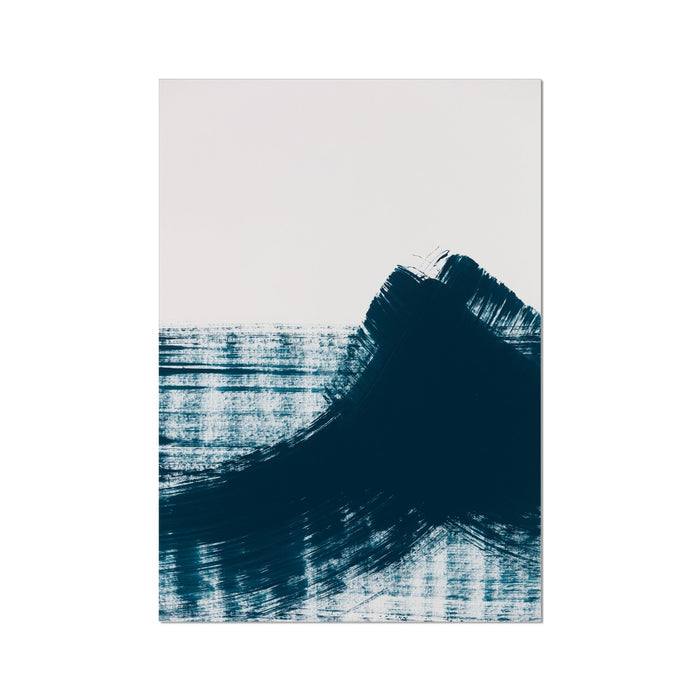 A framed abstract art print featuring swirls of dark blue and black on a light background, resembling ocean waves.