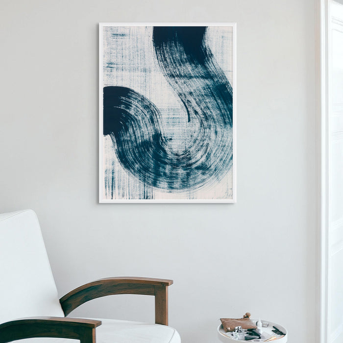 A framed abstract line art print in living room featuring sweeping blue strokes on a white background, presented in a wooden frame. Abstract coastal art print.