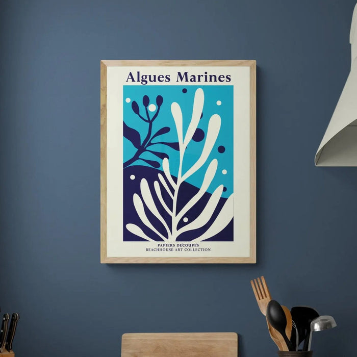 A blue seaweed art print, framed with a natural frame in kitchen.
