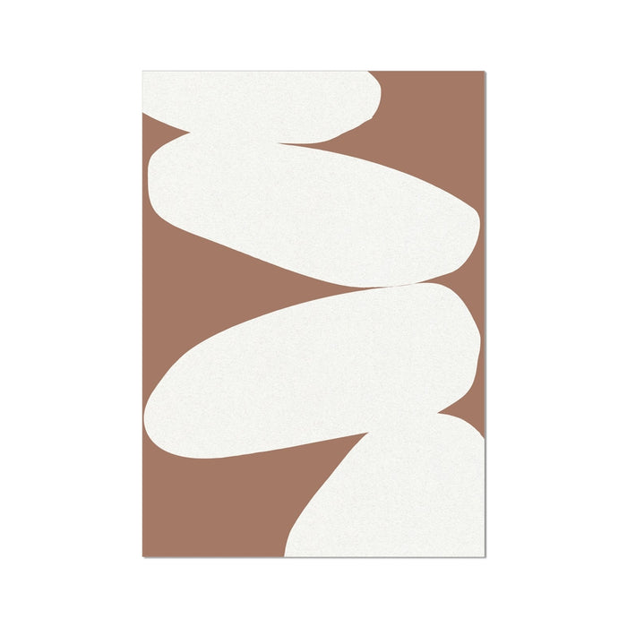 A framed abstract art print featuring an artistic representation of balancing stones in mocha and white colors.