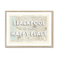 Framed Blackpool map print with the text 'BLACKPOOL is our HAPPY PLACE' overlayed on a map background, within a simple wooden frame.