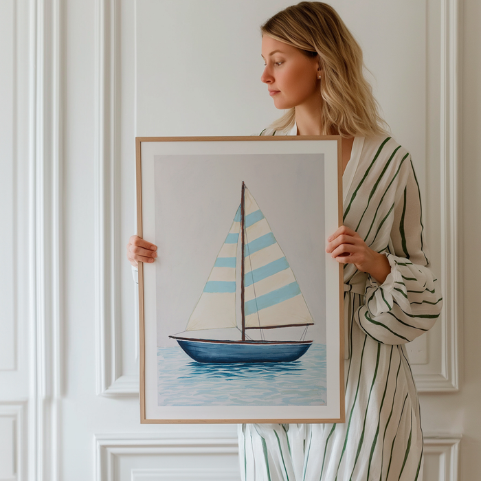 Woman holding a framed painting of a sailboat with a white wall background