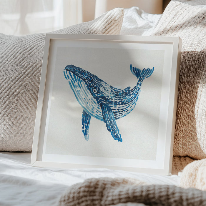 Blue whale painting framed in bedrom. the whale print is painted with layered blue watercolour brushstrokes on a neutral background