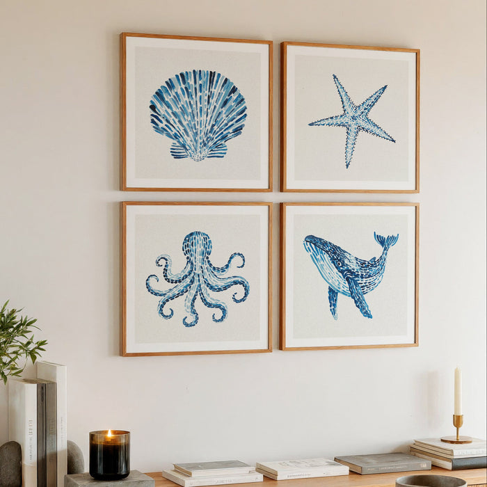 set of watercolour sealife paintings above sideboard in living room. Coastal living interior styling.