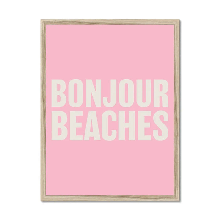 A framed word art print with the text 'BONJOUR BEACHES' in bold, white letters on a pink background.
