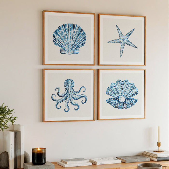 Set of four shell art prints on wall in living room