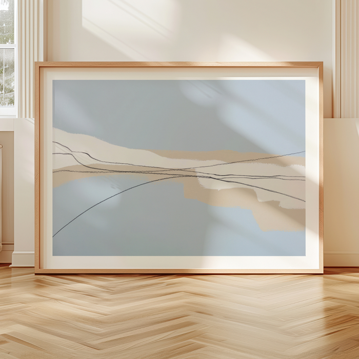 Framed abstract artwork on a wooden floor with a neutral wall background