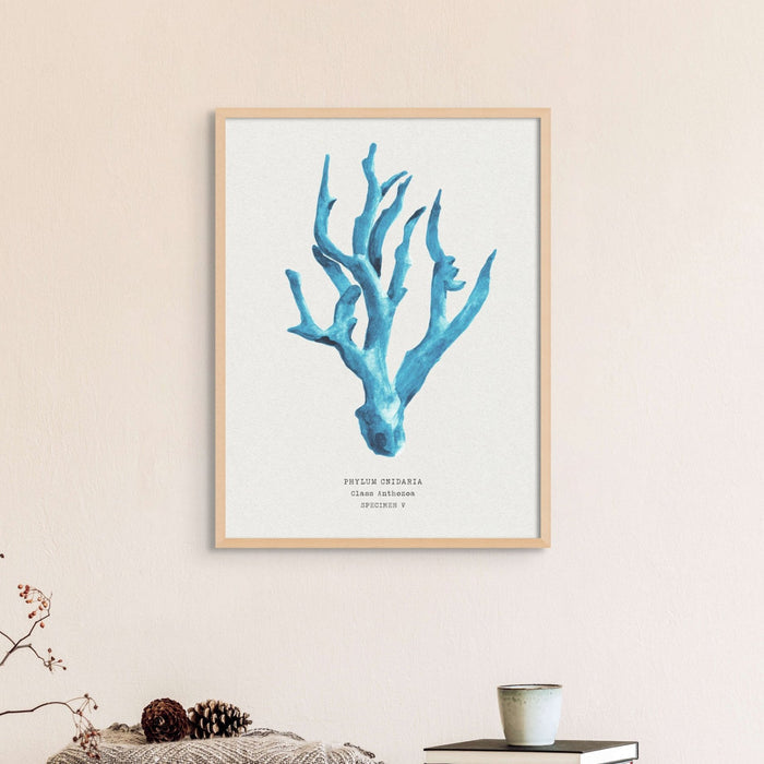 Set of three coral art prints - coral paintings as a set framed in natural frame above a bed.