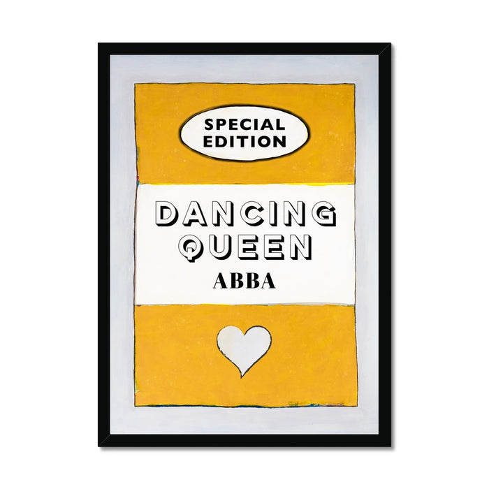 Framed art print of a vintage book cover with 'Dancing Queen' by ABBA as the title, predominantly yellow with black text, white heart, and a black frame.