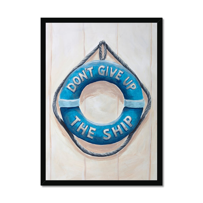 Framed artwork of a blue life buoy with 'Don't Give Up The Ship' text on a light wooden background.