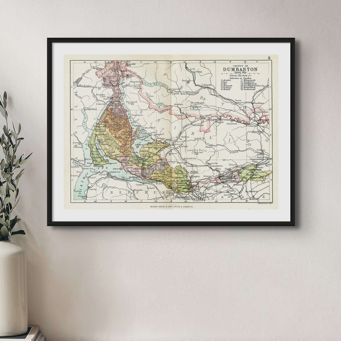 Framed vintage map print of Dumbarton and Loch Lomond with a simple black frame next to house plant.