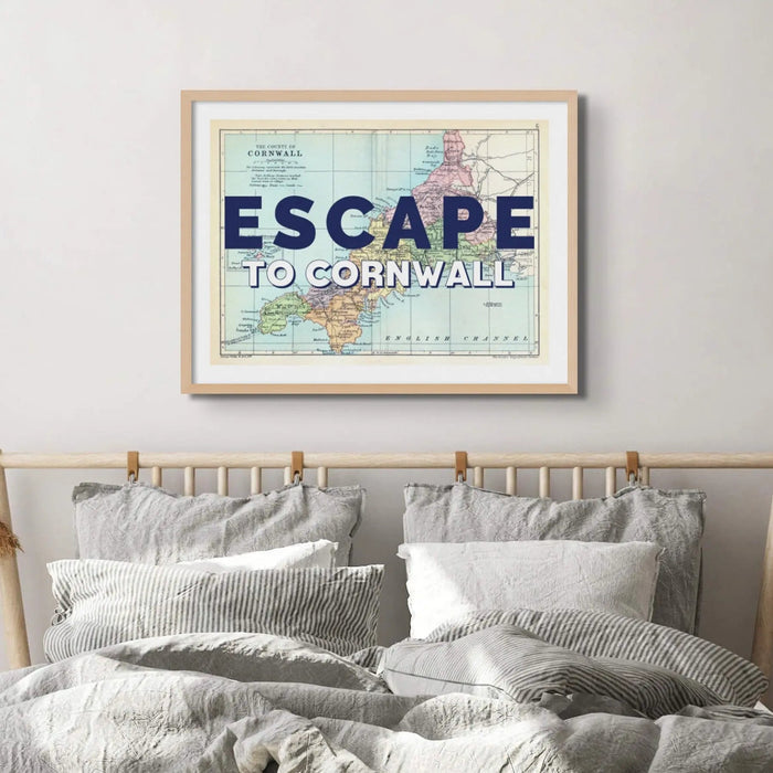 Framed vintage Cornwall map art print with the text 'ESCAPE TO CORNWALL' overlayed on a map background, in a simple clean line frame.