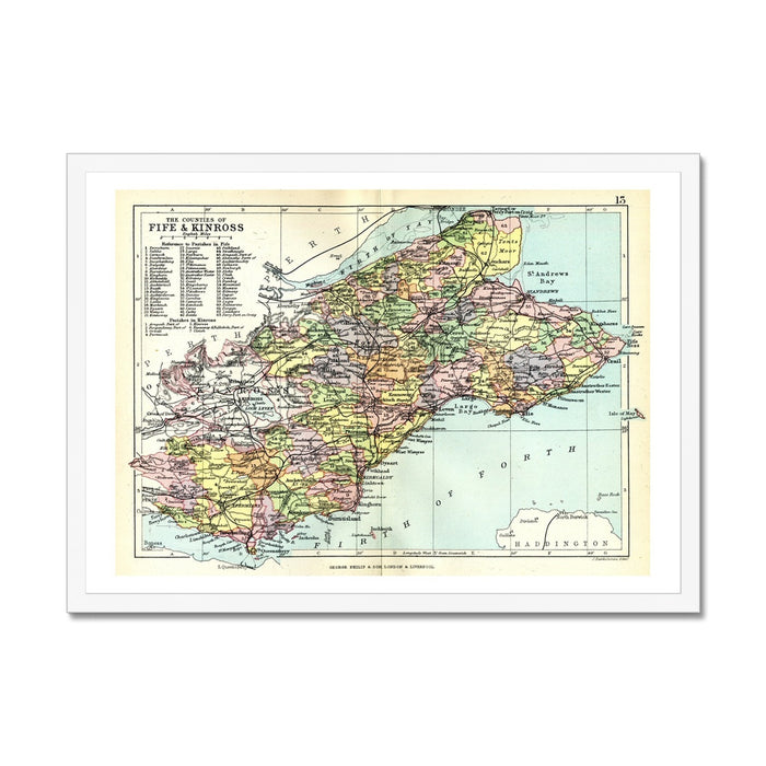 Framed vintage map print of Fife and Kinross, Scotland, on wall next to house plant. Featuring coloured cartography on a textured paper surface, enclosed in a black frame.