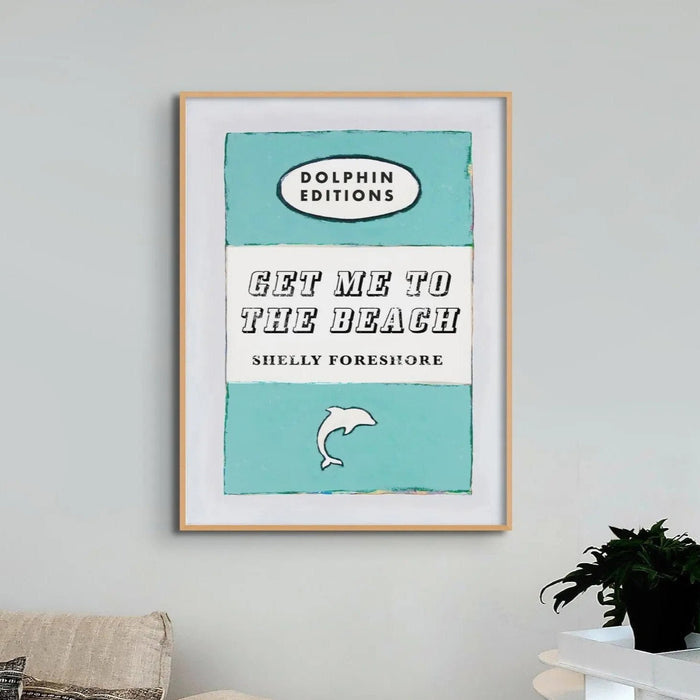 framed print of a vintage book cover art titled "Get Me to the Beach" in aqua blue