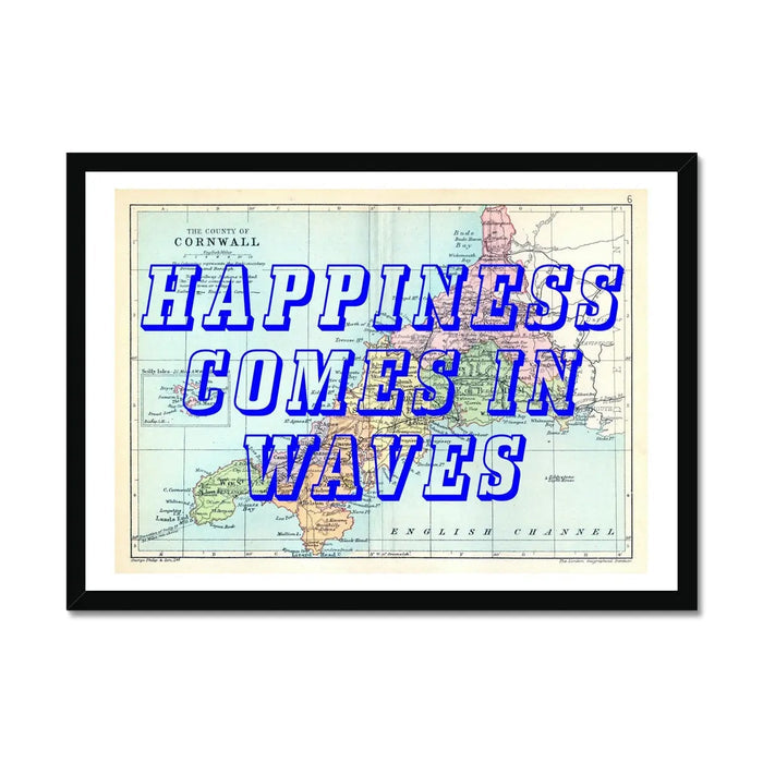Framed art print featuring a vintage map of Cornwall with the text 'HAPPINESS COMES IN WAVES' in bold, blue typography.