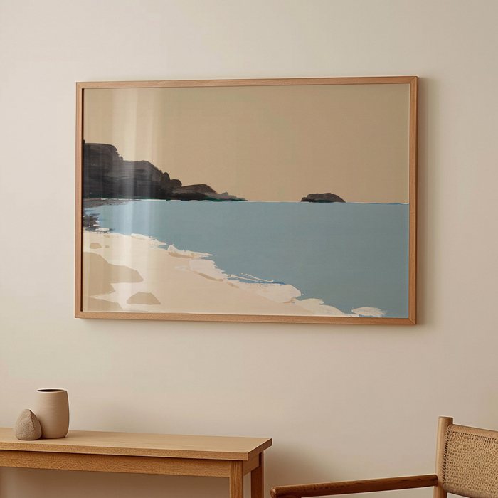 Framed artwork of a beach scene on a wall above a wooden table and chair.