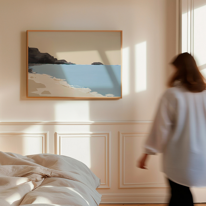 Woman walking in a bedroom with a large framed coastal beach artwork on the wall.