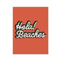 An orange art print with the text 'Hola Beaches' in a white and black font.