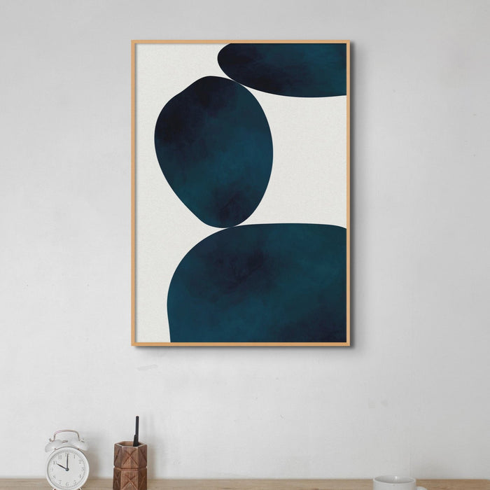 Abstract art print with blue abstract shapes framed on wall in office.
