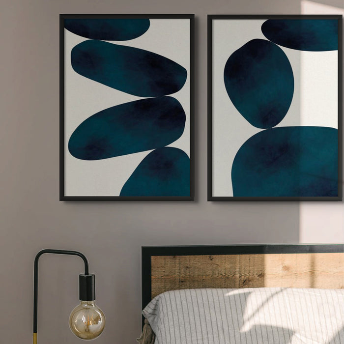 Set of two blue abstract art prints in bedroom.