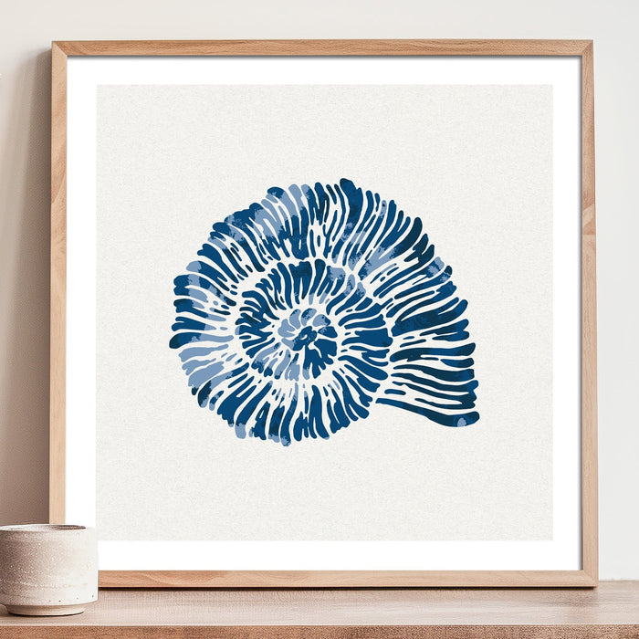 Blue shell art print in deep blue watercolour, square coastal wall art on white background. Framed with a natural wood frame on a shelf.