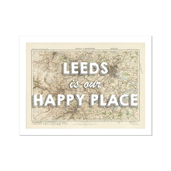 A framed map print of Leeds featuring a map with the text 'Leeds is our HAPPY PLACE' overlayed on it.