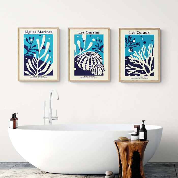 A set of three graphic botanical prints in bathroom above roll top bath.