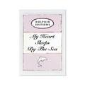 A framed poster with the title 'My Heart Sleeps By The Sea' in a pink color scheme, featuring a typography quote and a small graphic of a heart.