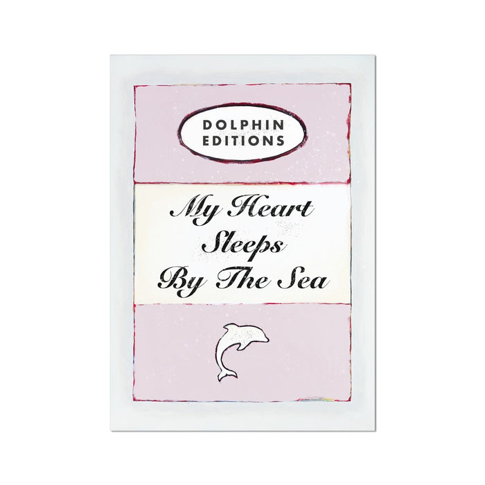 A framed poster with the title 'My Heart Sleeps By The Sea' in a pink color scheme, featuring a typography quote and a small graphic of a heart.