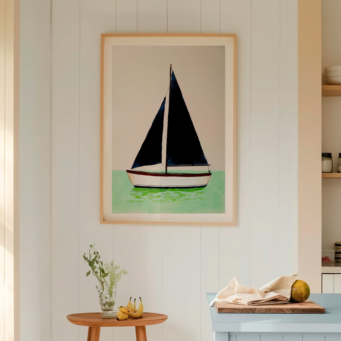 Framed artwork of a sailboat on a wall in a room with a table and plants.
