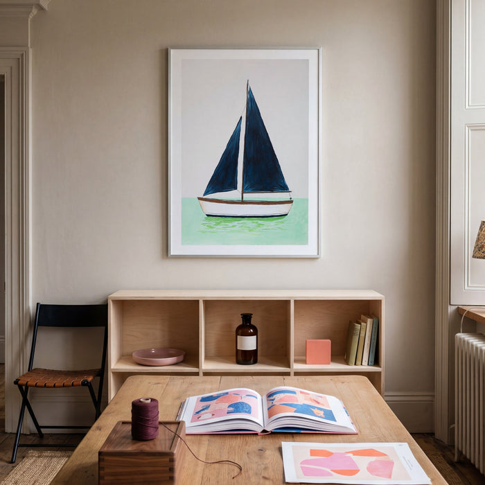 Room interior with a table, books, and a framed picture of a sailboat on the wall.