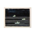 A framed art print featuring a modern seascape with fishing boats on the water, predominantly in shades of blue and white.