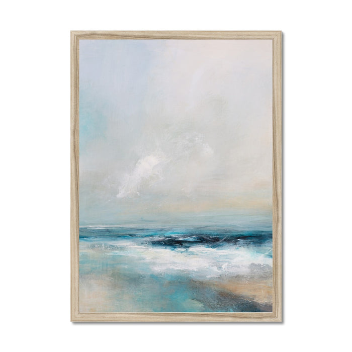 A framed art print depicting a serene coastal scene with gentle waves and soft colours, presented in a light wooden frame.
