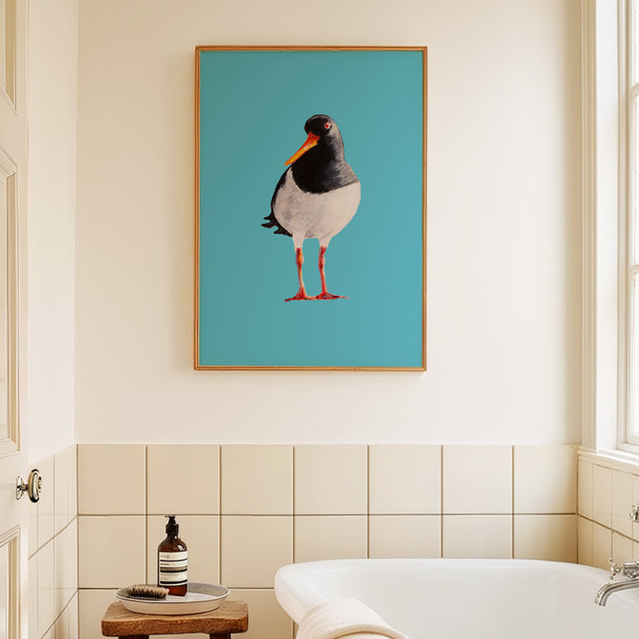Framed oystercatcher bird art print on a blue background in bathroom