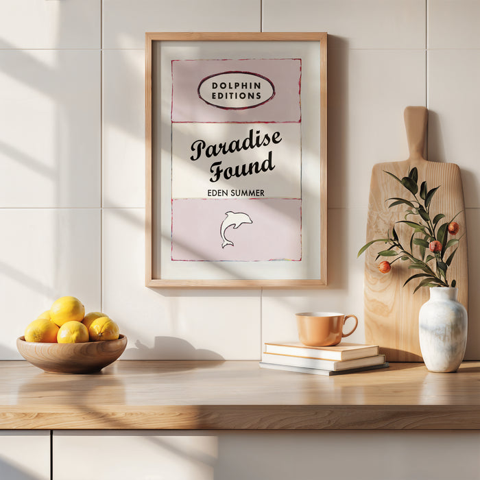 A vintage book cover art print with the title 'Paradise Found' by Eden Summer, featuring pink and white colours with typographic elements. quote print on book cover in kitchen. vintage style book cover art print with quote on in pink.