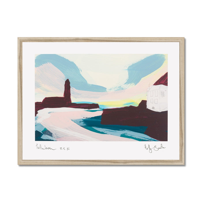 A framed abstract landscape art print featuring a stylized coastal scene with blue mountains, pink and white foreground shapes, dark brown rock forms, and a pale yellow band near the horizon. The print is mounted with a wide white mat and enclosed in a light natural wood frame, shown against a plain white background.