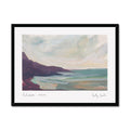 A framed landscape art print of Porthtowan in Cornwall featuring an impressionistic painting of a coastal scene with dark cliffs, turquoise water, and a cloudy sky, shown against a plain white background.