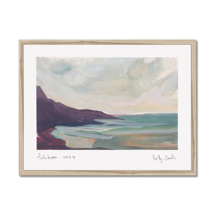A framed landscape art print featuring an impressionistic painting of a coastal scene with dark purple cliffs, green and blue water, and a cloudy sky, set in a light wood frame with a white mat.