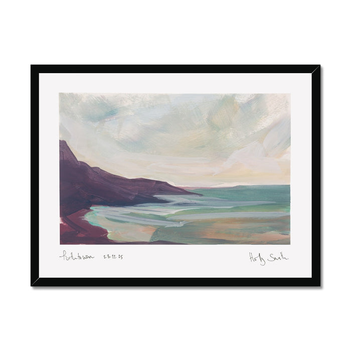 A framed landscape art print of Porthtowan in Cornwall featuring an impressionistic painting of a coastal scene with dark cliffs, turquoise water, and a cloudy sky, shown against a plain white background.