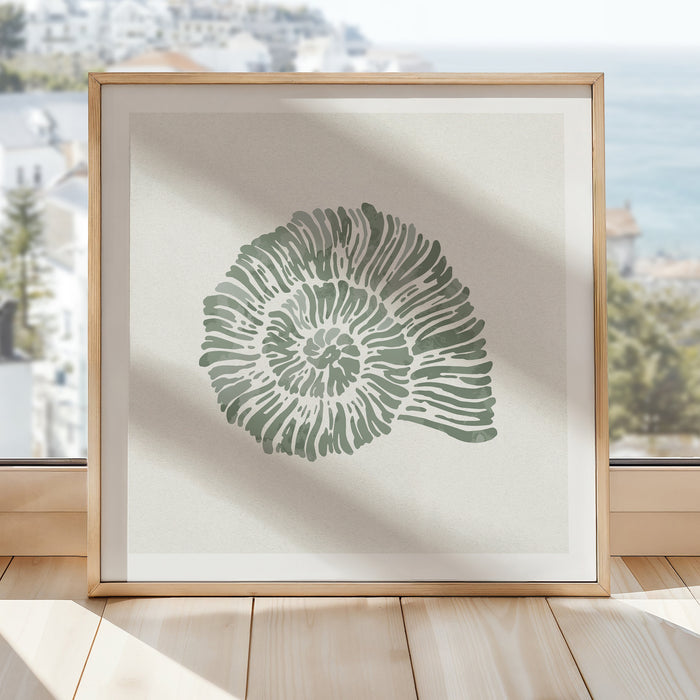 Sage green spiral shell art print in natural wood frame styled in a bright coastal interior