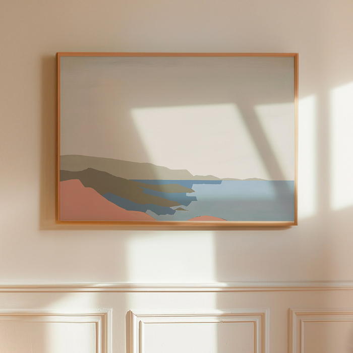 Framed pink abstract seascape artwork on a wall with sunlight casting shadows.