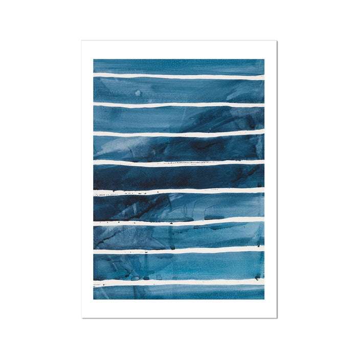 A framed abstract line art print featuring indigo and sea blue stripes, representing rolling ocean waves.
