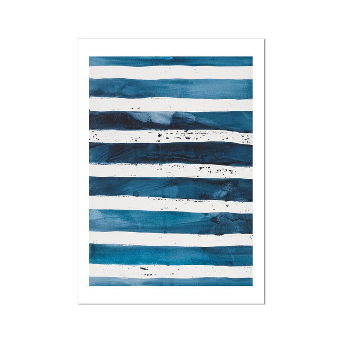 A framed abstract line art print featuring indigo blue watercolor stripes on a white background, resembling ocean waves.