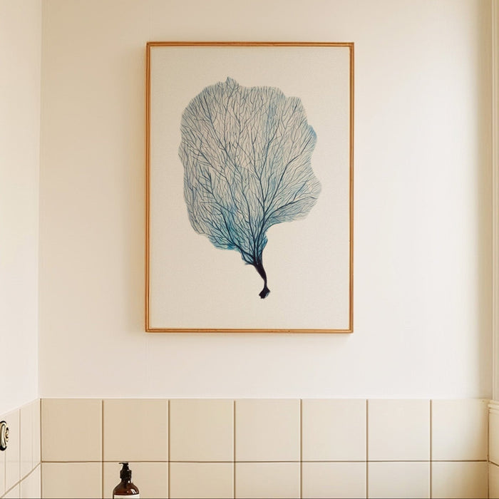 Framed artwork of a blue coral art print on a beige wall.