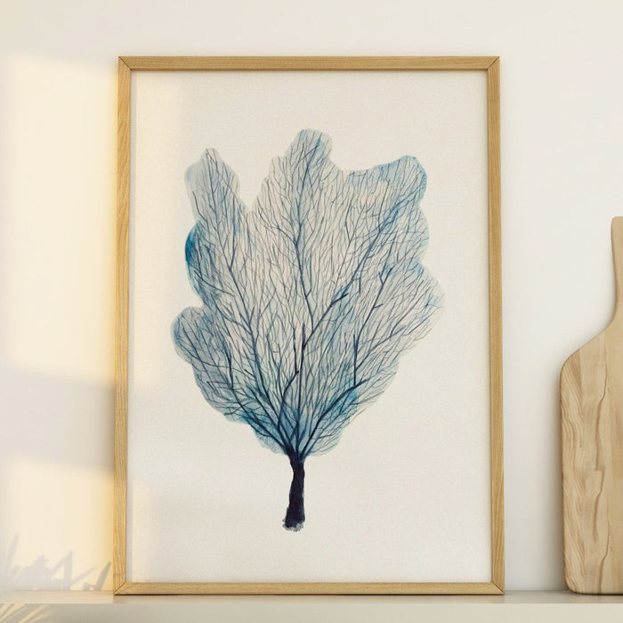 A framed print of a blue sea fan coral, with a simple white border and a wooden frame.