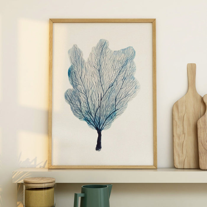A framed watercolour painting of a blue sea fan coral, with a simple white border and a wooden frame in kitchen.