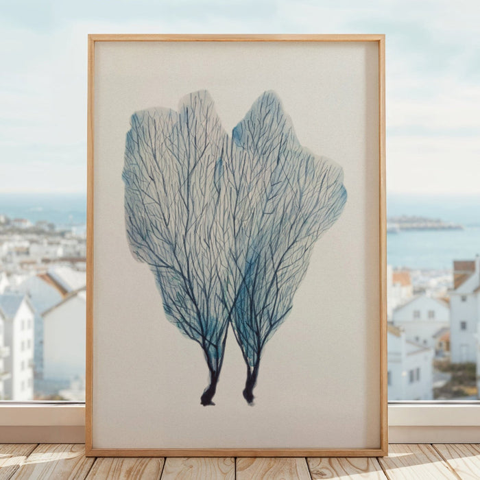 A framed watercolour painting of a blue sea fan coral, with a simple white border and a wooden frame.