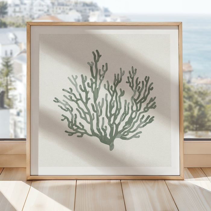 Sage green coral art print in natural wood frame styled in a bright coastal interior