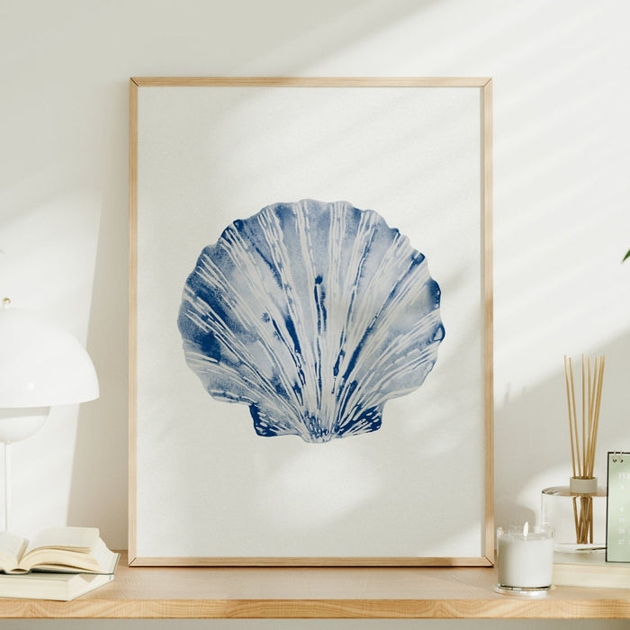 scallop shell art print framed on shelf in natural wooden frame.